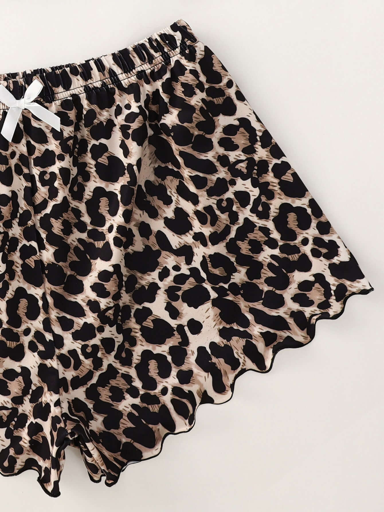 Leopard print shorts with scalloped edges and ribbon, part of a stylish home wear suit in black polyester.