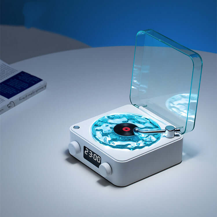 Retro turntable speaker with blue light and clear lid on a bedside table, showcasing vintage design and modern technology.