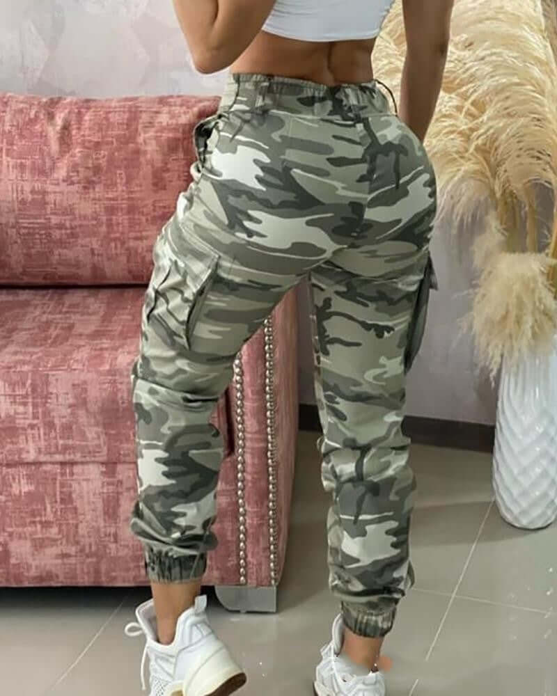 Back view of women's camouflage casual trousers featuring a relaxed fit and elastic waist, styled with a cropped top.