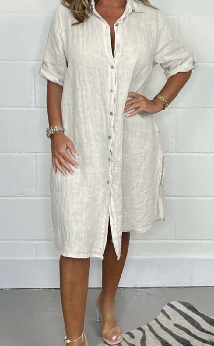 Casual half sleeve solid color cotton linen shirt dress in light beige on model, featuring A-line silhouette and button front.