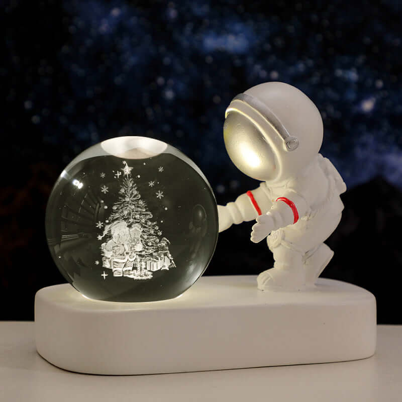 Astronaut figurine with glowing crystal ball featuring a Christmas tree, perfect for a warm night light.
