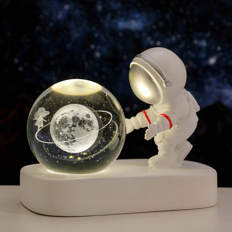 Astronaut figure with glowing crystal ball featuring a moon and planets, creating a warm bedside atmosphere.