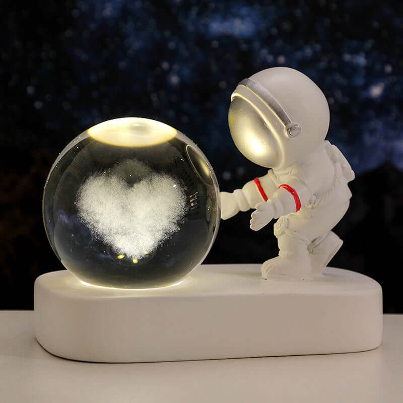 Astronaut figurine with heart design crystal ball night light, creating a warm atmosphere, perfect for gifts and decor.