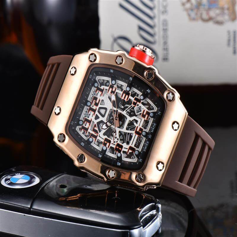 Stylish brown rubber strap watch with bold dial and gold accents, placed beside a BMW key fob.