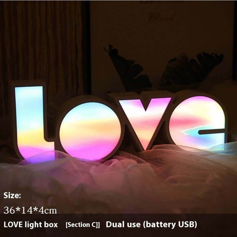 Colorful LED LOVE light box for decorative holiday layouts, dual power (battery/USB), 36x14x4cm size.