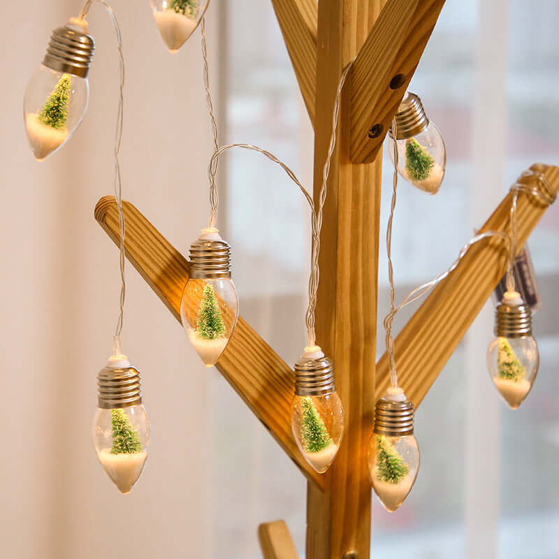 LED fairy lights with miniature Christmas trees, ideal for holiday decor on Christmas trees and indoor settings.