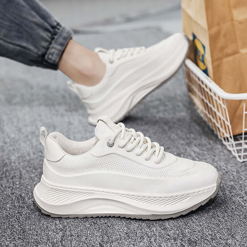 Stylish white thick-soled sports shoes with lace-up design, perfect for casual wear and comfortable foot support.