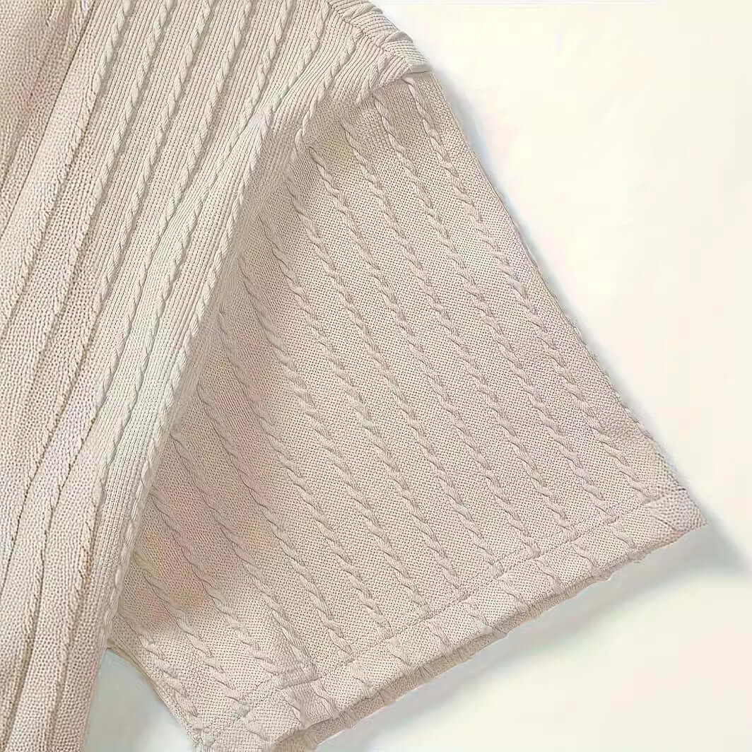 Close-up of men's casual short sleeve top in milky white cotton with textured knit design.