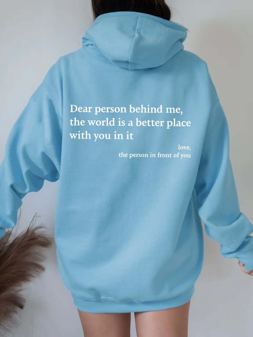 Women's blue hoodie with text "Dear person behind me, the world is a better place with you in it" on back.