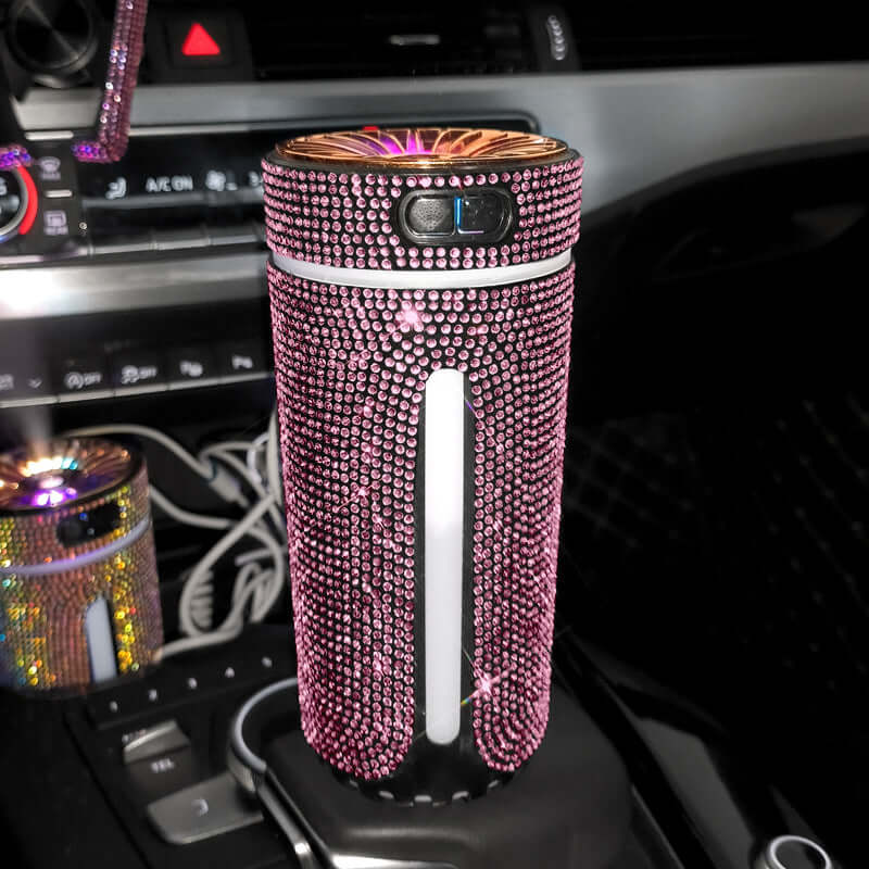 Luxury pink diamond-studded car humidifier and diffuser in a vehicle, adding style and aroma to your driving experience.