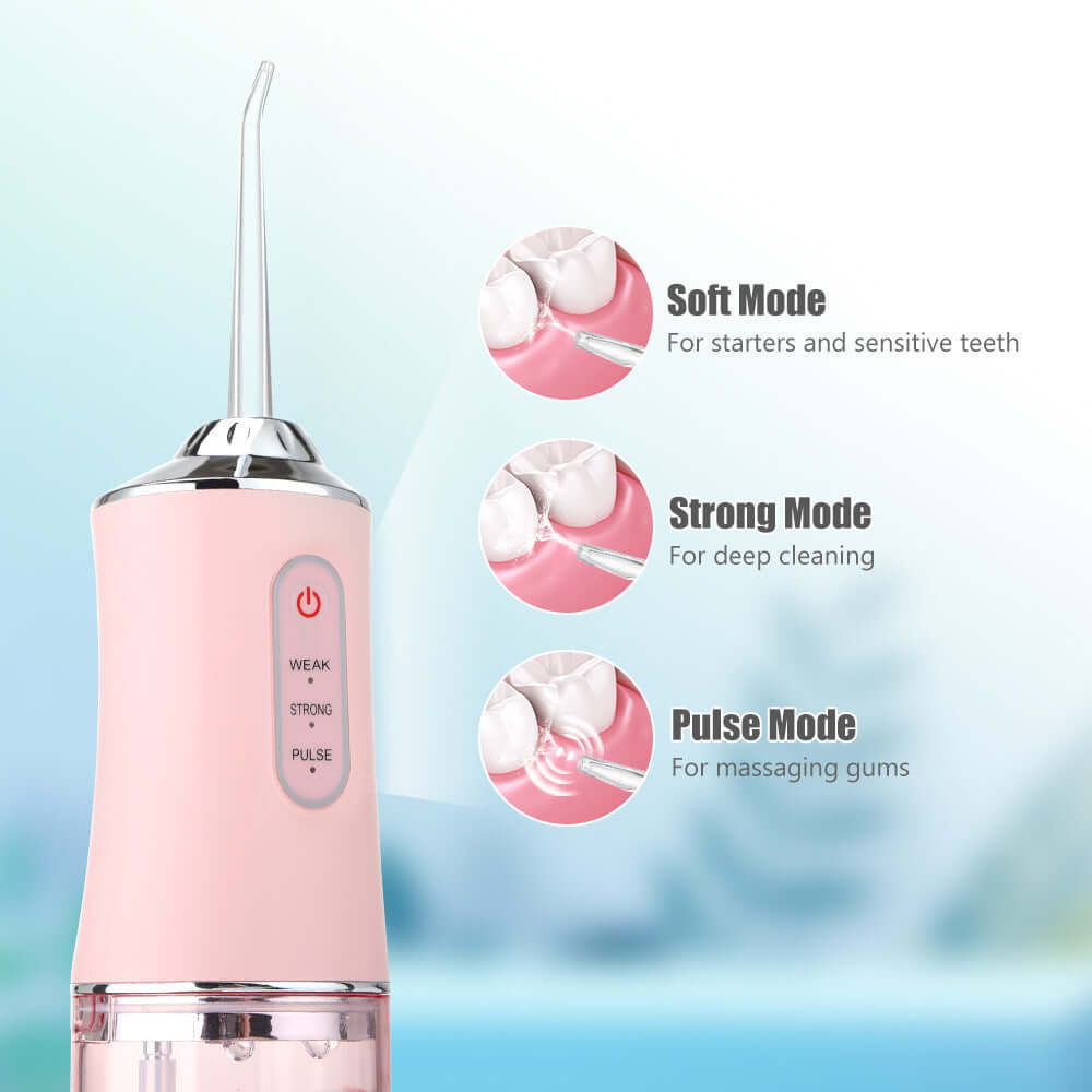 Hand-held electric dental irrigator in pink color with soft, strong, and pulse modes for effective oral care.