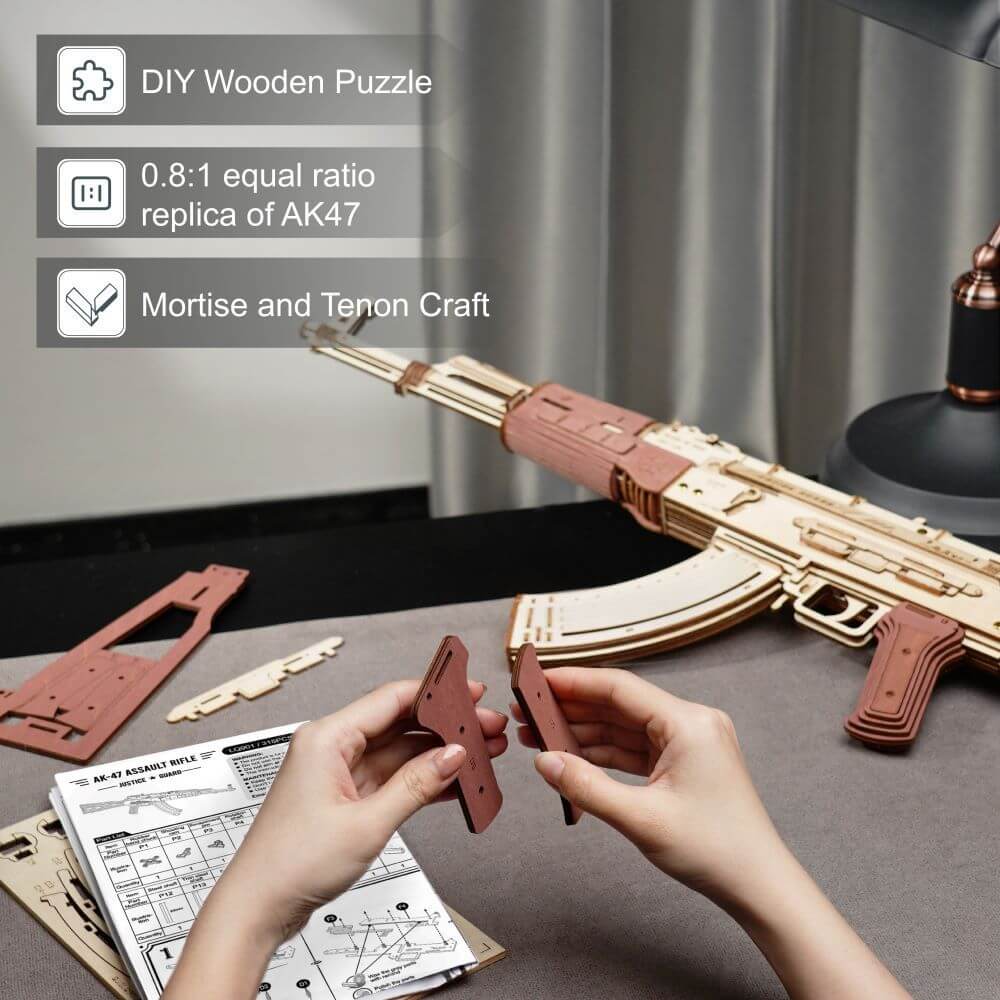 Hands assembling a DIY wooden puzzle of the AK-47 model with detailed parts and instructions on a table.