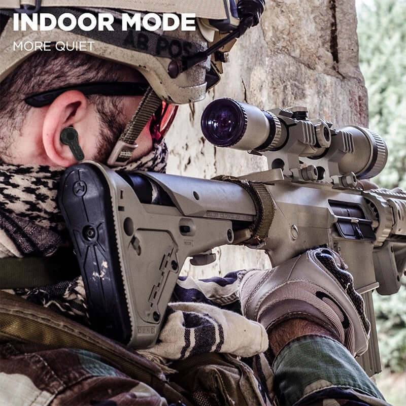 Soldier using tactical noise reduction headset while aiming a rifle in indoor mode for quieter operation.