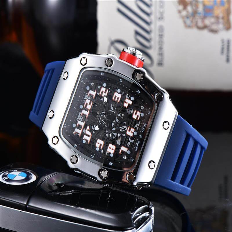Stylish blue rubber strap quartz watch with a square dial, metallic case, and bold numbering against a blurred background.
