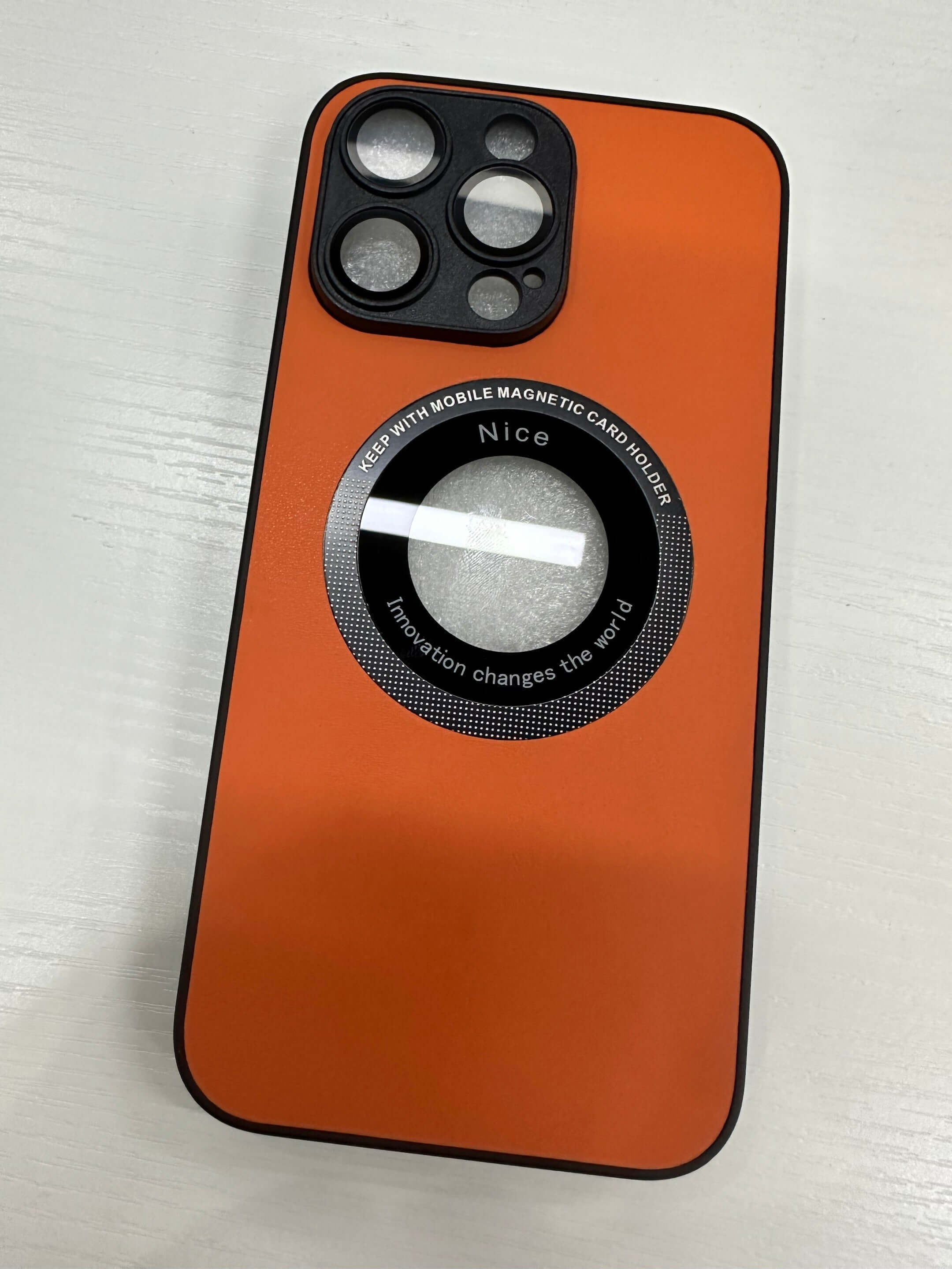 Orange mobile phone case featuring a magnetic card holder with embossed design for sleek protection.
