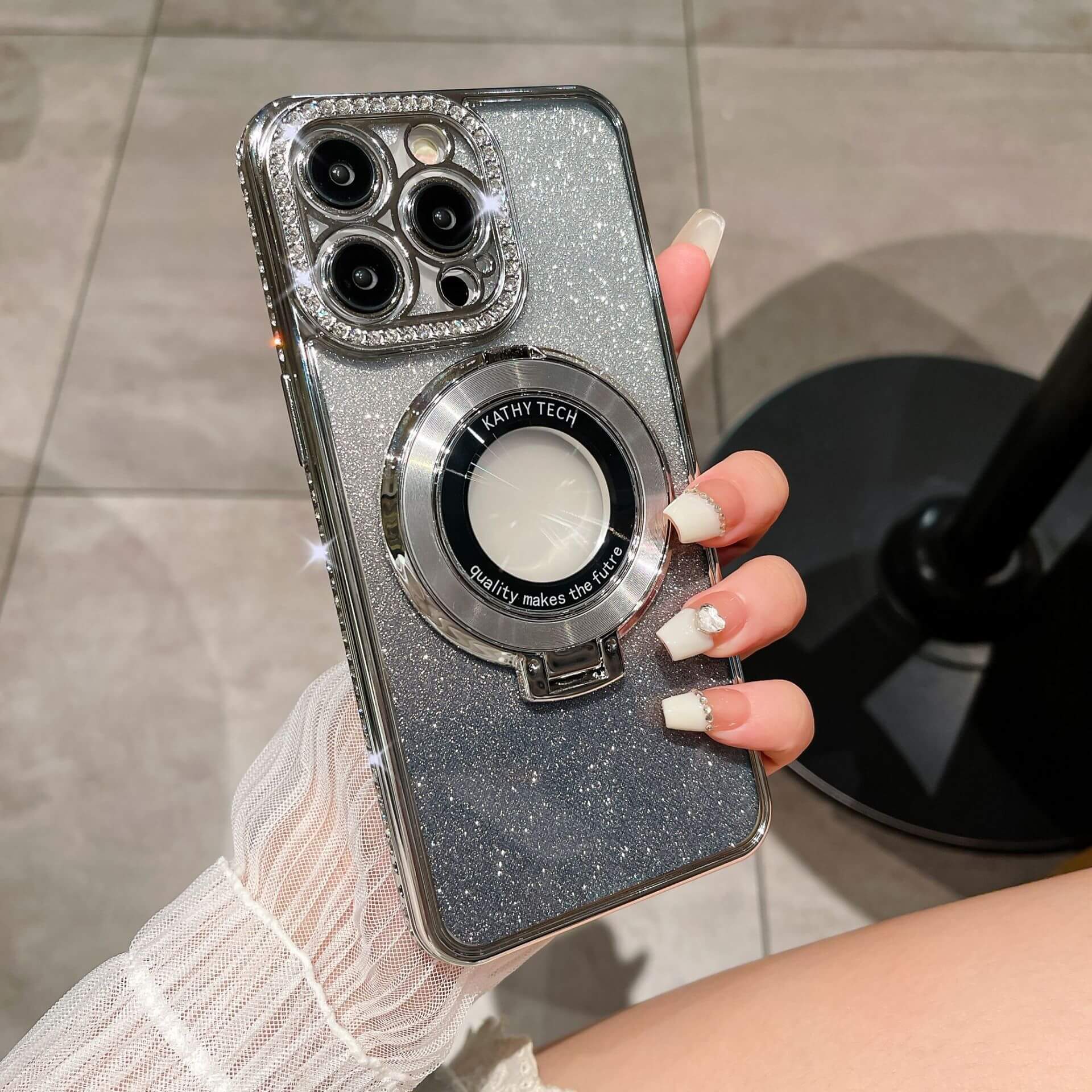 Glitter TPU electroplating magnetic bracket phone case in hand, showcasing its sparkling design and functionality.