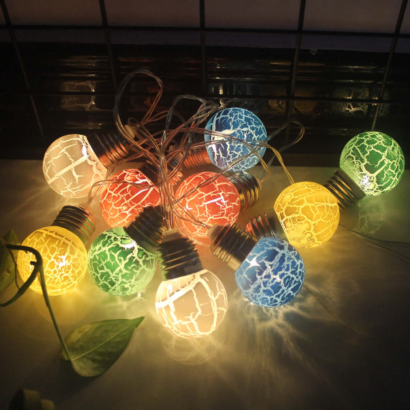 LED cracked bulbs in various colors, decorative lights on a string for festive occasions.
