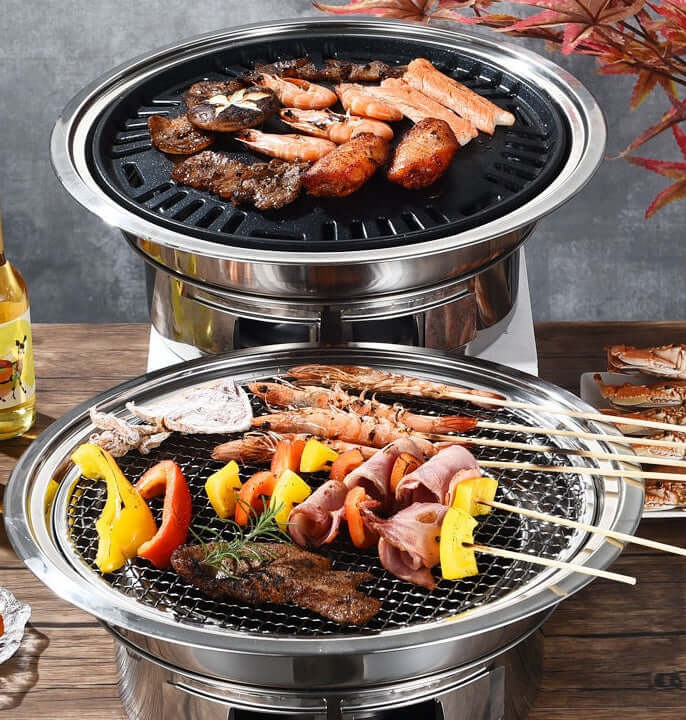 Korean stainless steel charcoal barbecue grill with grilled meats and vegetables, perfect for consumer and commercial use.