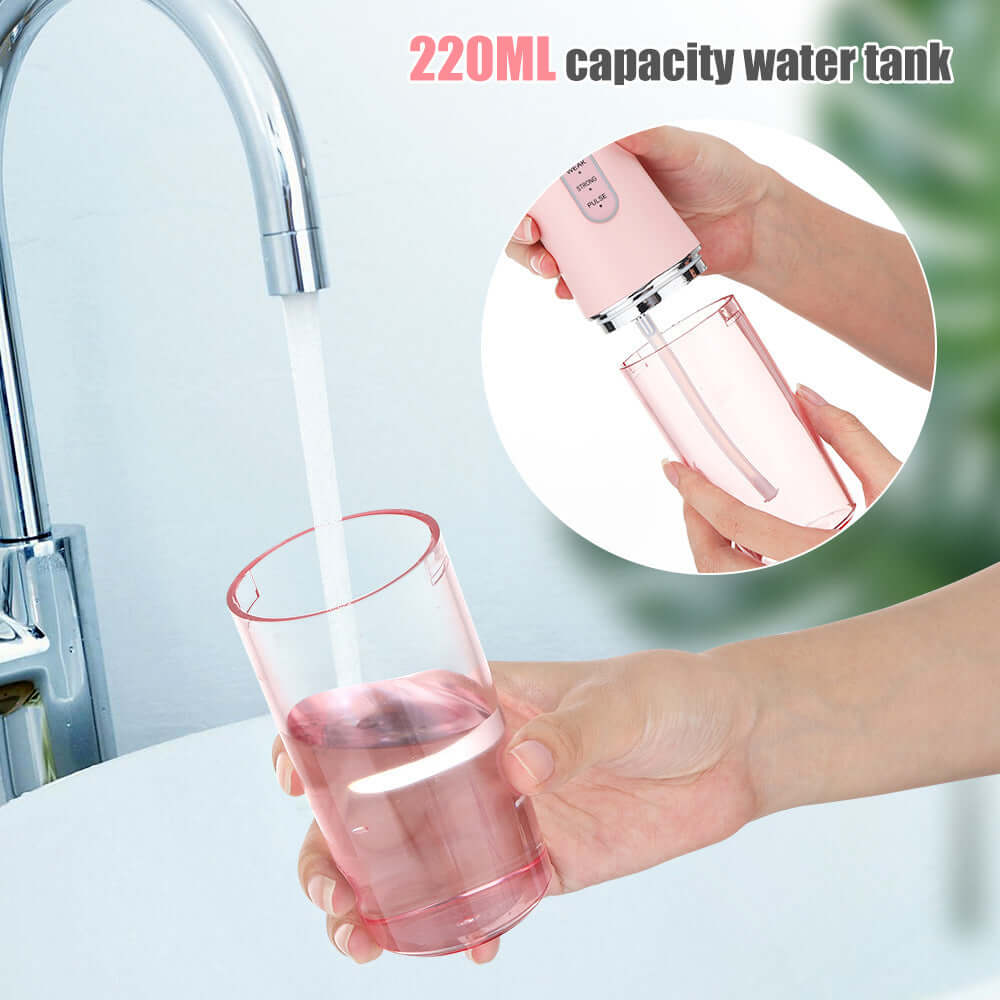 Hand-held electric dental irrigator with 220ml water tank, filling water from a faucet, showcasing its portable design.