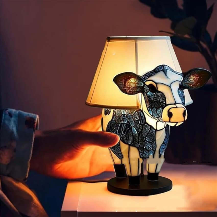 Beautiful cow table lamp with fabric shade, perfect for bedroom or living room decor, highlighting vintage design.
