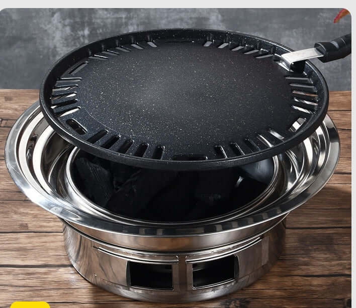 Korean stainless steel charcoal barbecue grill with non-stick grilling plate, ideal for commercial and consumer use.