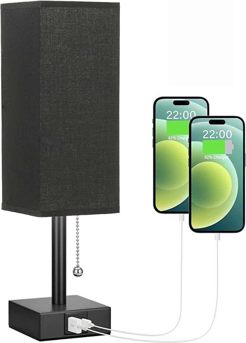 Small bedside table lamp with USB charging, pull chain for brightness control, and two smartphones charging.