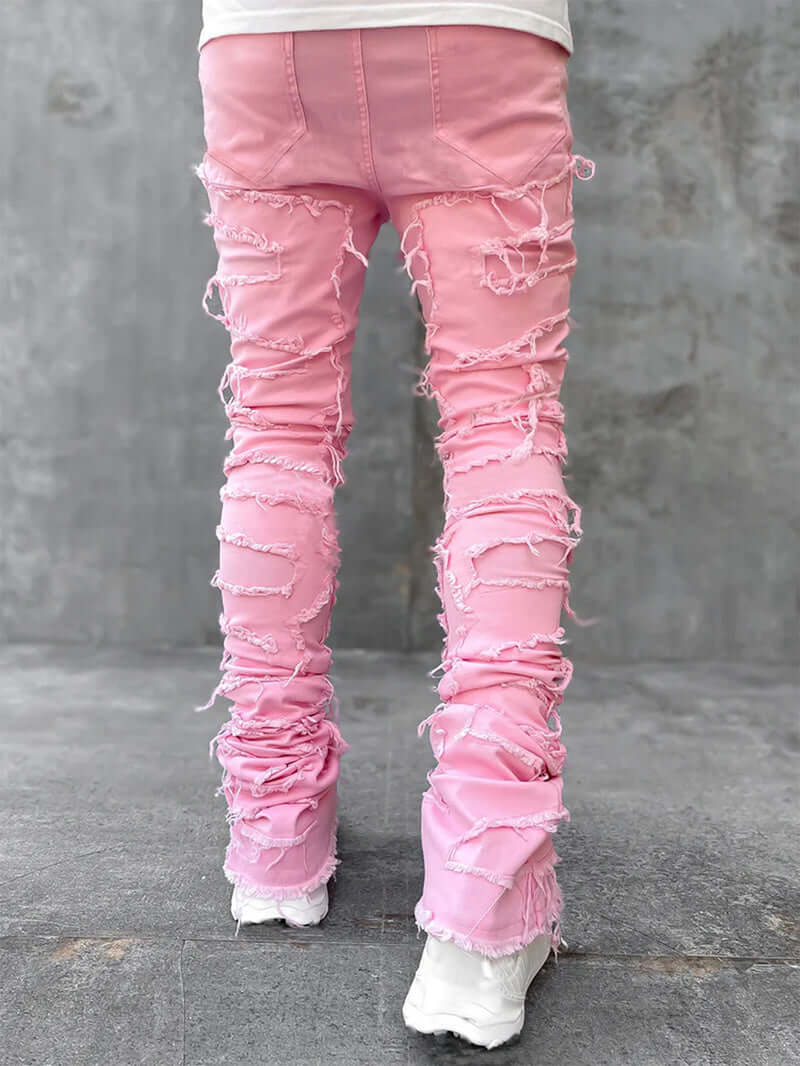 Men's pink stacked jeans with unique patch design and distressed finish, perfect for stylish casual wear.