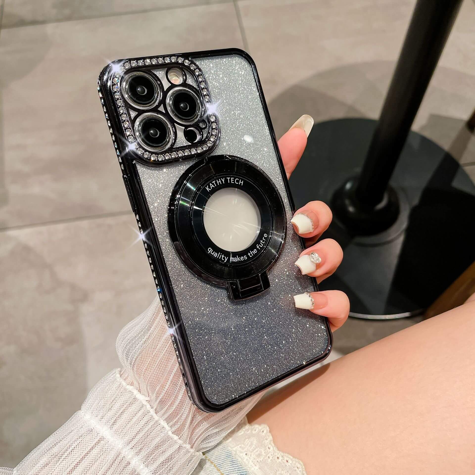 Glitter TPU electroplating magnetic bracket phone case in hand, featuring sparkly design and functional magnetic grip.