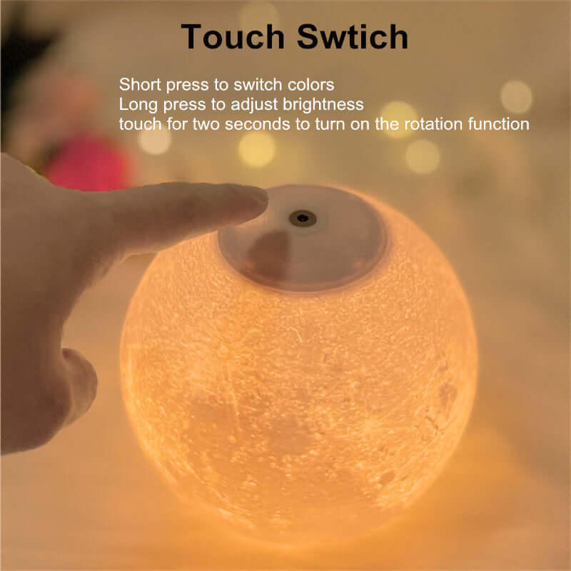 Hand touching the touch switch on a 3D magnetic levitating moon lamp to change colors and adjust brightness.