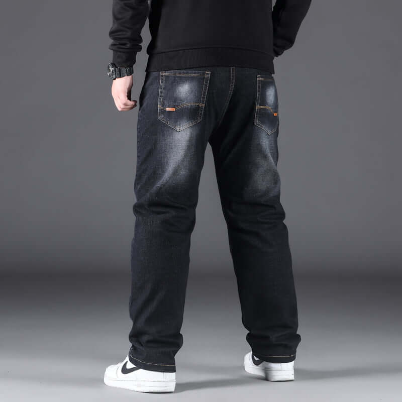 Men's casual straight pants in dark denim, showcased from behind, featuring a relaxed fit and minimalistic design.