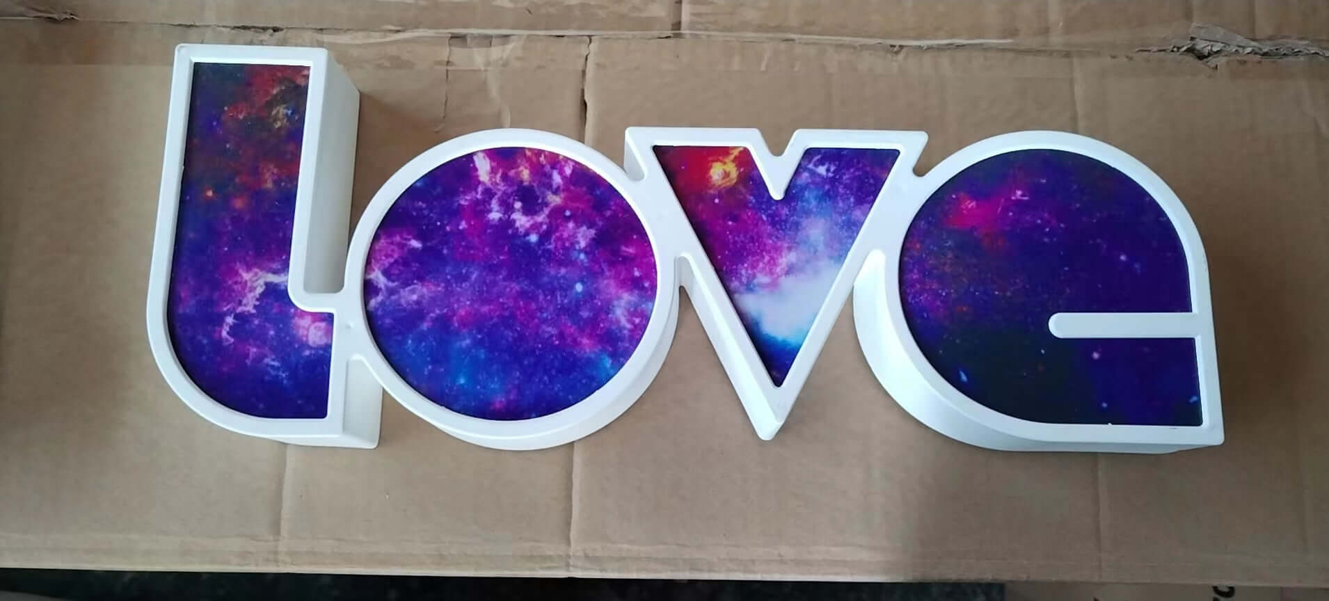 Colorful LED 'LOVE' letter decorative light with galaxy design for holiday and romantic occasions.