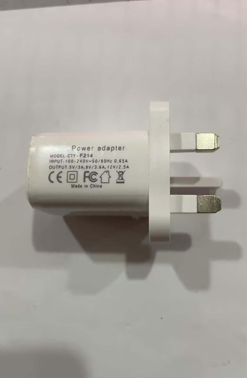 White power adapter with UK plug and specifications for charging electronic devices.