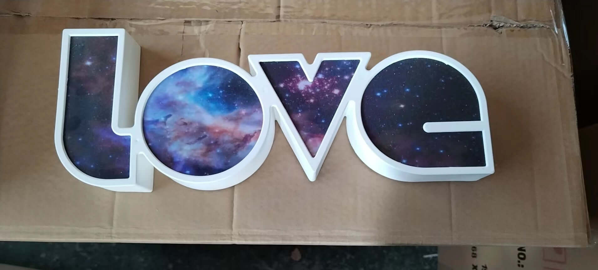 LED decorative light shaped like the word LOVE with a starry sky design, ideal for holiday and home decor.