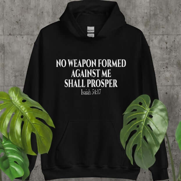 Black hoodie with text "No weapon formed against me shall prosper" from Isaiah 54:17, suitable for autumn wear.