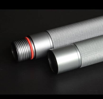 Close-up of two interconnected tactical stick components with textured silver finish and red detail.