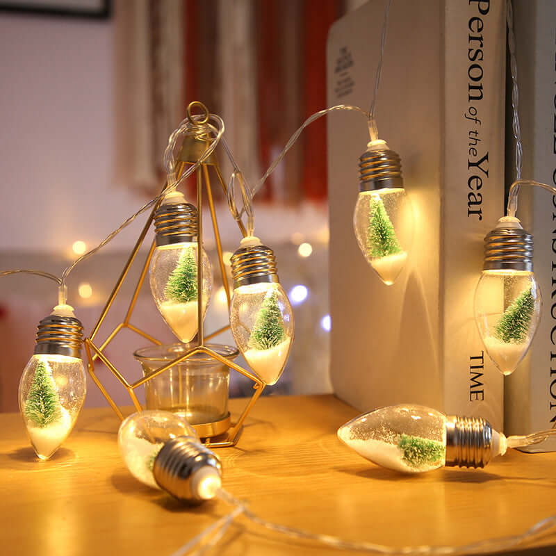 LED fairy lights featuring transparent bulbs with miniature Christmas trees, perfect for holiday decor and celebrations.