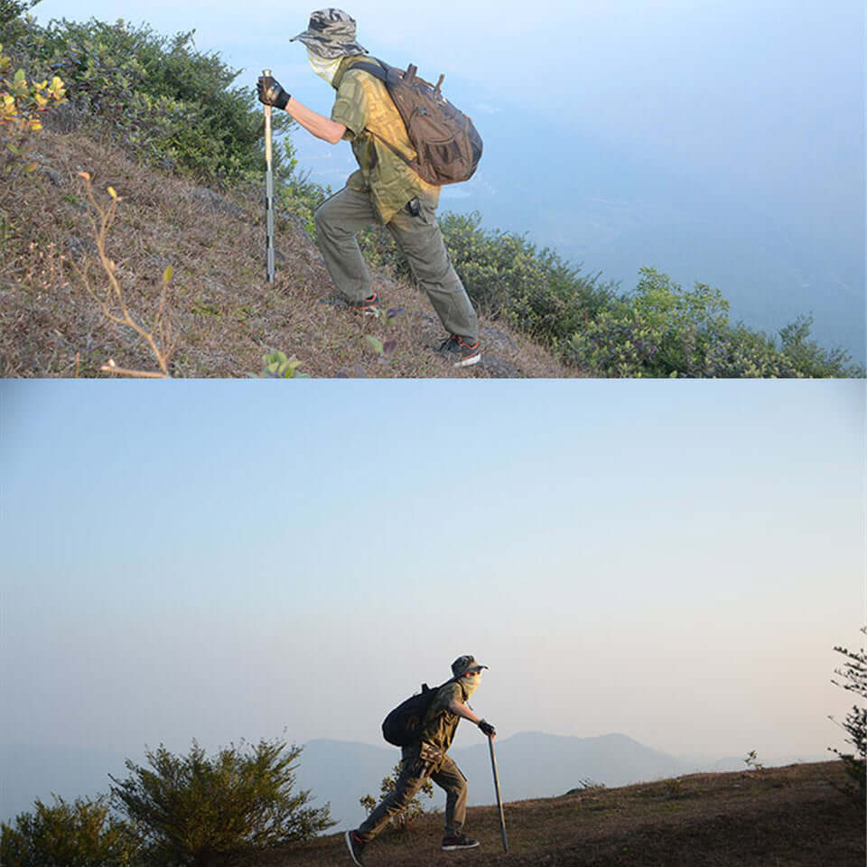 Person using Outdoor Defense Tactical Stick while hiking on a scenic mountain trail.