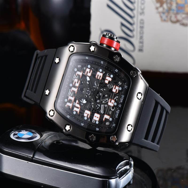 Stylish black quartz watch with rubber strap and bold dial design next to a BMW car key.