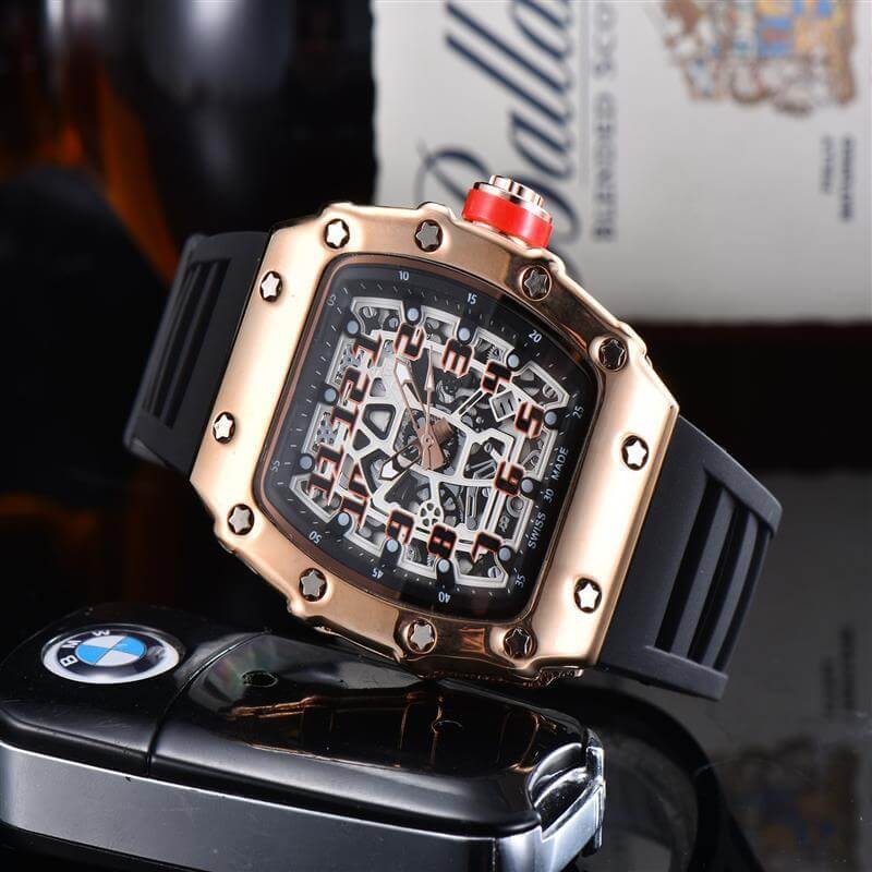 Stylish gold and black quartz watch with a skeleton dial, displayed alongside a BMW key fob.
