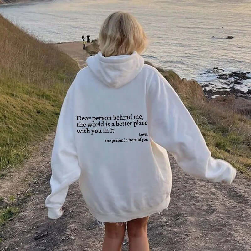 Unisex white hoodie with quote 'Dear person behind me, the world is a better place with you in it' on the back.