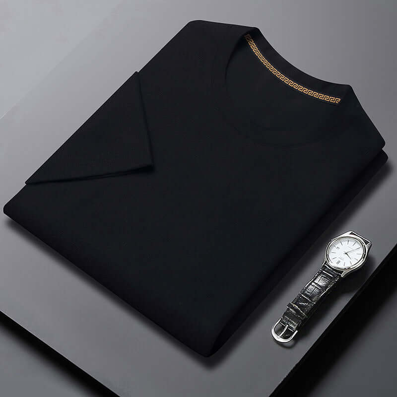 Men's black round neck breathable half sleeve top with a stylish watch on a sleek surface.
