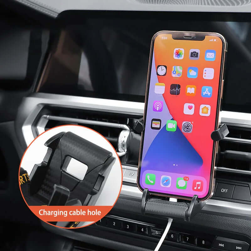 Racing seat shaped air vent phone holder with charging cable hole, securely holding a smartphone in a car.