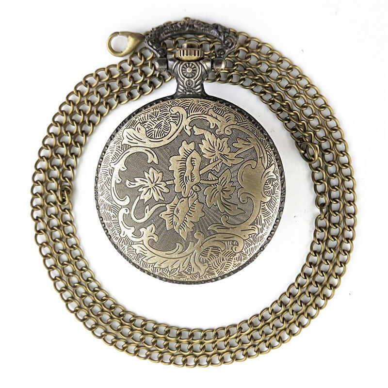 Antique large bird design vintage pocket watch with intricate etching and thin chain, perfect for collectors.