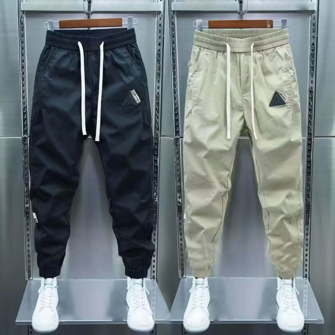 Men's summer cropped overalls in black and khaki, featuring drawstring waist and ankle banded style for leisure wear.