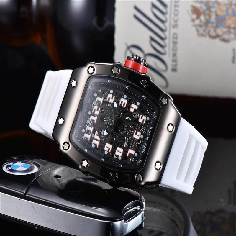Stylish quartz watch with white rubber strap and bold black dial on display beside a car key.